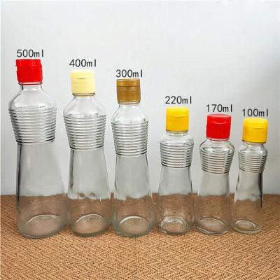 China Hot Sale 100ml 220ml 300ml Frying Oil Glass Sauce Oil Bottles With Plastic Lids Kitchen Frying Oil Bottle Clear Empty Olive Oil Bottle for sale