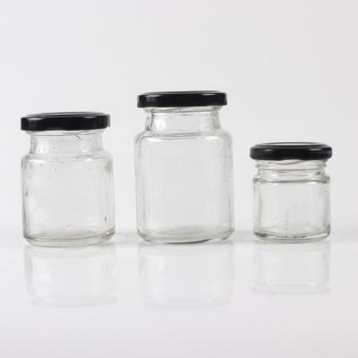 China Viable Round 50ml 75ml 100ml Bulk Glass Jar Storage Supplies Mini Glass Jar For Birds Nest Drinks Sauce Food Jam With Black Metal Lid for sale