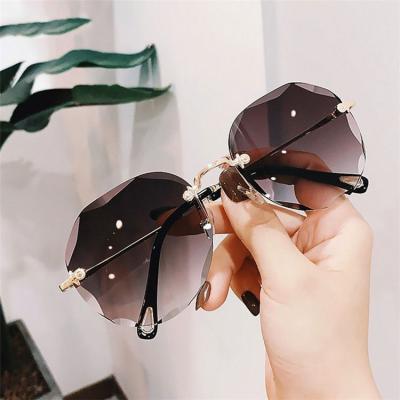 China Internet Celebrity Recommend Tinted Lens Cutting Rimless Round Wholesale Brand Sunglasses Women Shades for sale