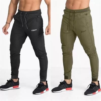 China Estación de primavera para hombre de la fuente del servicio del OEM de los pantalones del ejercicio del diseño de los bolsillos con cremallera en venta