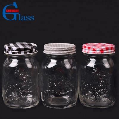 China Freshness Preservation Maker Embossed Borosilicate Storage Jar Glass Bottle Jars 16oz Glass Mason Jar With Tinplate Lid for sale