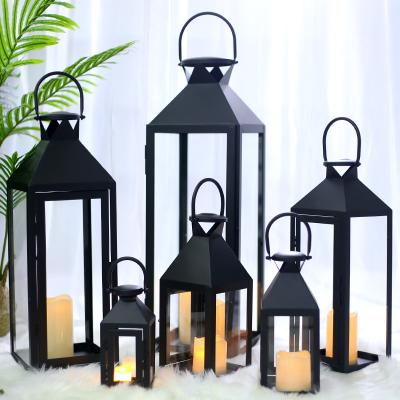 China Simple Chinese Portable Windproof Glass Outdoor Black Candle Holder Wrought Iron Metal Lantern Candlestick Decoration Europe Retro for sale