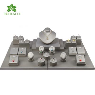 China RuiKaiLi Jewelry Customized Luxury Jewelry Store Display Props Jewelry Display Stand Gray Leather Earrings/Rings/Necklaces Jewelry Moves for sale