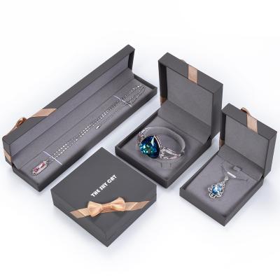 China Fresh Flower Packaging RuiKaiLi Fashion Bow Jewelry Packaging Leather Filled Paper Gold Box,Ring Pendant Box With Customized Logo for sale