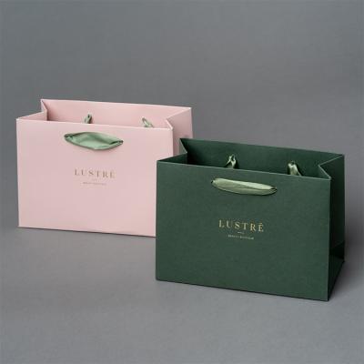 China Custom Disposable Ribbon Handle Luxury Boutique Gift Bags Printed Gift Paper Bags With Logo for sale