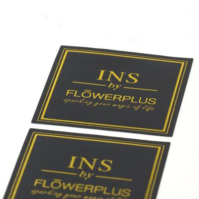 China Custom Heat Sensitive Matte Black Label Flower Sticker Logo Label Printing Gold Stamping Sticker for sale