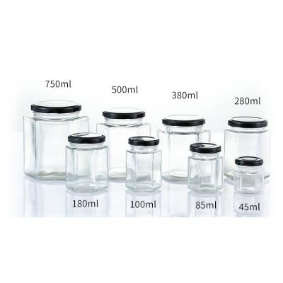 China Freshness Storage 45ml 85ml 100ml 180ml 280ml 380ml 500ml 730ml Hexagona Honey Jar Hexagon With Lids for sale