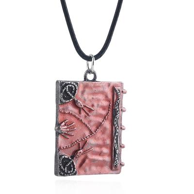 China The Other King Yee Factory Wholesale Cheap Halloween Jewelry Demon Book Necklace Magic Pink Pendant for sale