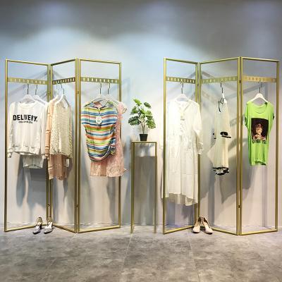 China Removable and environment-friendly golden floor style clothing store clothing hanging racks racks store design for sale