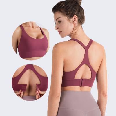 China Hot sale four way women custom stretch crop tops with outlet design sexy hollow out sports bra gym wear vest for sale