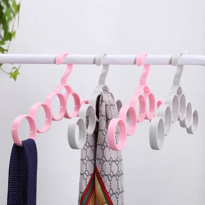 China 6 Holes Eco-friendly Scarf Hanger Plastic Neck Tie And Scarf Hanger Organizer Belt Circles for sale