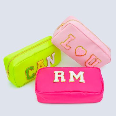 China Durable High Quality Lazy Pink Cosmetic Bag High Capacity Promotional Cosmetic Bag Patch Letter for sale