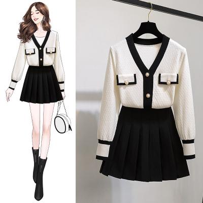 China Anti-pilling Coat 2021 Autumn Winter Button Up Knitted Fashion Pleated Skirt Set Black White Contrast Color V-Neck Sweater 2 Piece Suite for sale