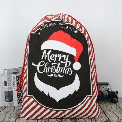 China Stylish Rope Drawstring Christmas Gift Tote Bag Santa Claus Versatile Stripe Drawstring Kids Candy Bags for sale