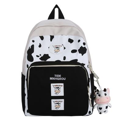 China 2021 Waterproof New Cute Cow Pattern Backpack Lighting Ridge Protection Child Canvas Travel Backpack School Bags Large Capacity 30*13*40cm for sale