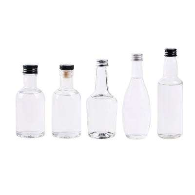 China Wine/beer/beverage 50ml 100ml rounded mini glass wine bottle with aluminum cap favors bottles for water juice milk for sale