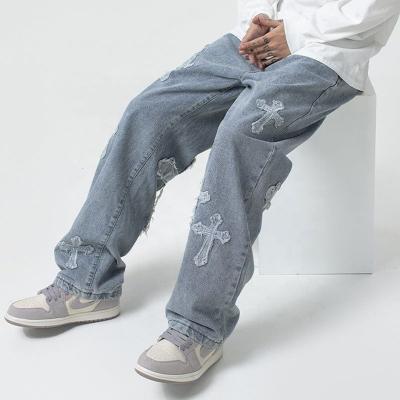 China New Arrival Breathable Hot Sales Designer Rocket Jeans Mens Loose Jeans Men Cross Applique Denim Fabric for sale