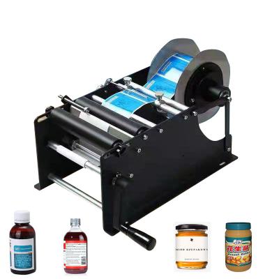 China beverage makwell manual mineral water plastic bottle labeling machine for round sticker label packing machine for sale