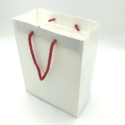 China Outdoor Waterproof White Packaging Paper Bag Nylon Ribbon For Shopping for sale