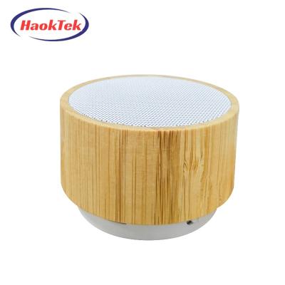 China HAOKTEK 2023 New Design Wireless Speakers Mini Portable Wooden Round Small Bluetooth Outdoor Speaker for sale