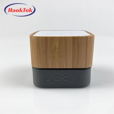 China Viable Mini Portable Wireless Bamboo Wooden Speaker LED Flashing Light HAOKTEK Square Led Small Light Blue Tooth Speaker for sale