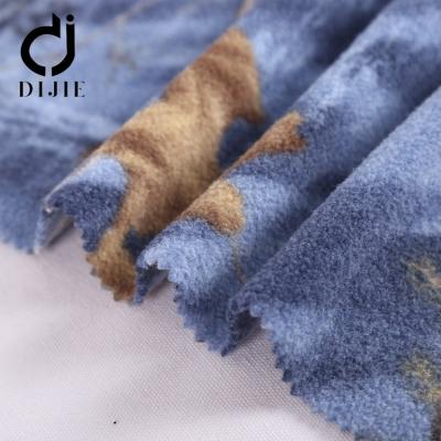 China Anti-Static Wholesale 100 Polyester Dragon Printed Blue Used Apparel Velvet Upholstery Fabric For Winter Dres for sale