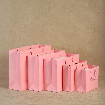 China Gift Free Good Quality Strong Pink Paper Bag Design Art Paper Luxury Women Handling Bags With Handle 21*14*27cm for sale