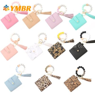 China 2022 Hot Selling Environmentally Friendly Silicone ID Girls Leather Tassel Sunflower Wooden Beaded Bracelet Wristlet Wallet Credit Cards Cards for sale