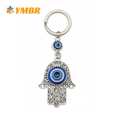 China Fashionable Heart Shaped Rhinestone Glass New Design Hamsa Key Chain Silver Evil Eye for sale