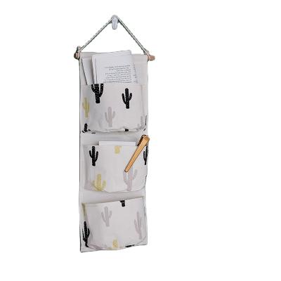 China Sustainable Factory OEM Cotton Canvas Storage Bags Foldable Wall Hanging Organizer for sale