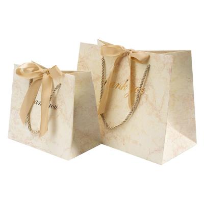 China Recyclable Custom Your Own Logo Printed Recyclable Luxury Kraft Paper Packaging Clothing Paper Shopping Bags With Black Ribbon Handle for sale