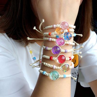 China New BOHEMIA Design Lucky Flower Bracelets Handmade Woven Glass Dried Flower Charm Bracelets Adjustable Life Bracelet for sale