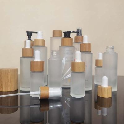 China Wholesales Cosmetics Perfume Essential Oil 30ml 50ml 100ml 120ml 150ml Frosted Glass Cosmetic Bottle With Bamboo Spray Or Pump Cap for sale