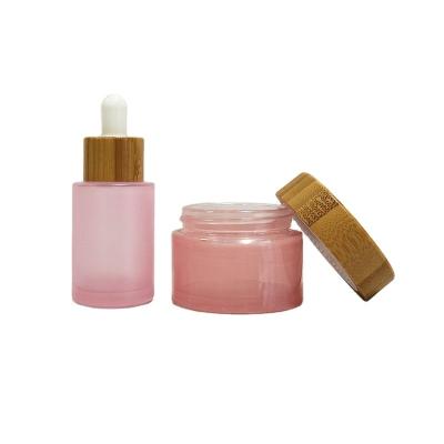 China Customized 10ml 15ml 30ml 50ml 60ml cosmetic transparent pink bamboo jars and bottles for cosmetic lotion pump spray bottle for sale