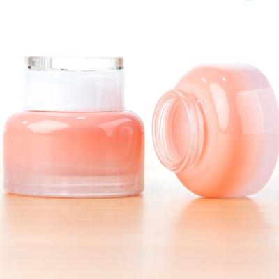 China 30g 50g Round Skin Care Peach Pink Color Empty Glass Cream Jar Glass Cosmetic Jars With Plastic Cap For Face Cream for sale