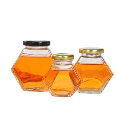 China Sustainable Transparent Hexagonal Glass Cover Honey Jar Airtight Tinplate 380ml Glass Bottle for sale