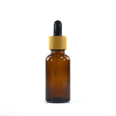 China Eco-Friendly Recyclable Wholesale 5ml - 100ml Custom Bamboo Lid Amber Glass Bottle Dropper Glass Essential Oil Bottle for sale