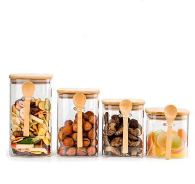 China Sustainable High Borosilicate Square Jar Kitchen Storage Glass Canister With Bamboo Wood Lid For Food Honey Cookie Tea Candy Packaging for sale