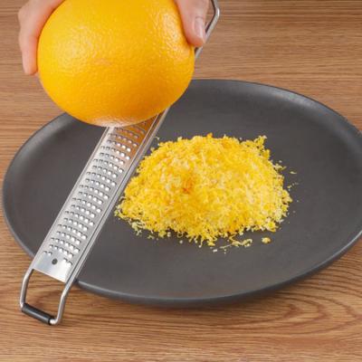 China Sustainable Multifunctional Hand Held Wooden Handle Carrot Zester Stainless Steel Cheese Vegetable Grater for sale