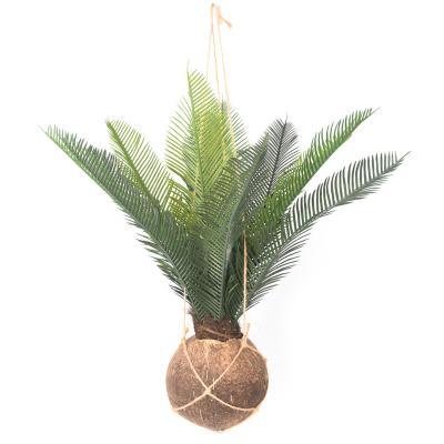 China Indor Indoor Decoration Greenery Decor Fake Palm Leaves Coconut Shell Based Artificial Wall Hanging Plant With Pot for sale