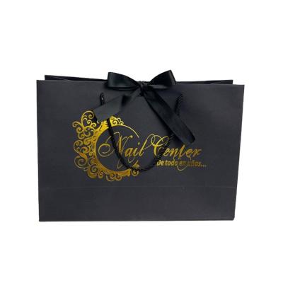 China Luxury Recycled 100% Materials New Black Card Recycle Paper Bag, Hot Stamping Black Gold Logo Kraft Paper Bag With Tie Ribbon for sale