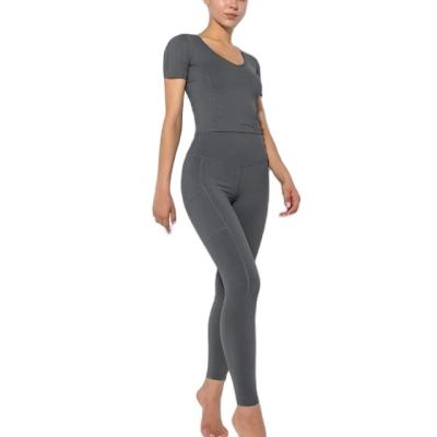 China Breathable Solid V-Neck Yoga Suit With Pockets Workout Leggings Short Sleeved Yoga Set High Elastic Sports Suit for sale