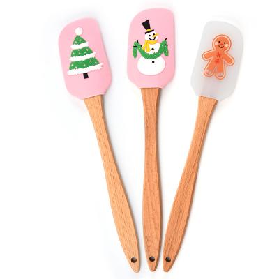 China Sustainable Christmas Gingerbread Man and Snowman Tree Pattern Kitchen Silicone Spatula Set Christmas Cake Decorating Wooden Handle for sale