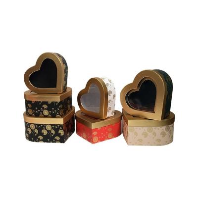 China Recyclable gold heart-shaped transparent window opening hollow PVC window surprise obvious gift rose flower soap head flower gift box for sale