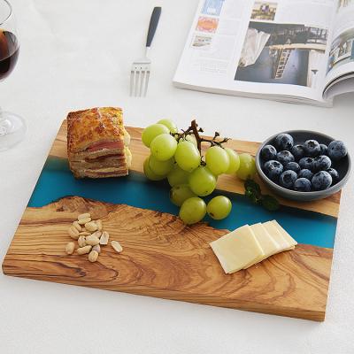 China Viable New Arrival Luxury Design Olive Wood Blue Epoxy Resin Cutting Cutting Board Serving For Charcuterie for sale