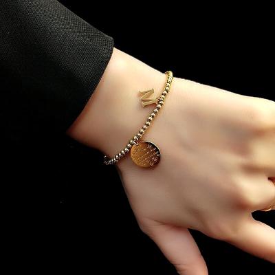 China AFXSION New Girl's Bracelet 18K Gold Jewelry CLASSIC French Elastic Beaded Rope Letter Stainless Steel Pendant Bracelet for sale