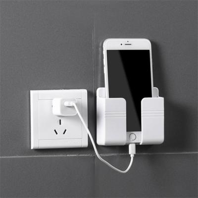 China Popular Stock Multifunction New Wall Phone Holder Adhesive Mobile Charger And Remote Control Stand for sale