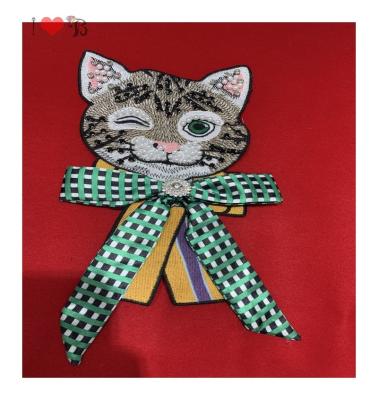 China Soft to touch a closed eye cute cat wearing green bowknot patch for garment decoration, delicate embroidered cat patch for sale