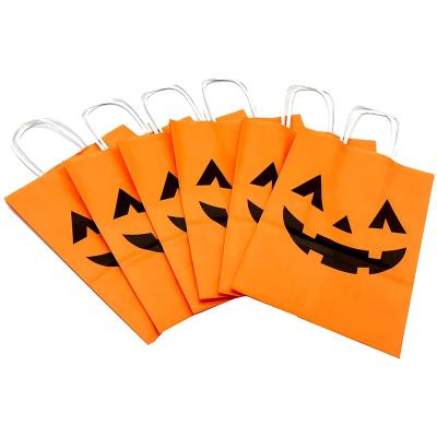 China Recyclable Kraft Paper Gift Candy Packaging Bags With Drawstrings Handles Halloween Pumpkin Favor Bag for sale