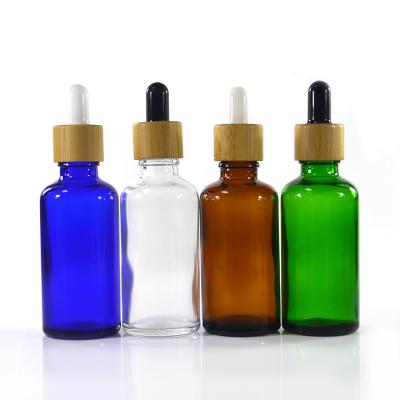 China 10ml 20ml 30ml 50ml 100ml cosmetic matte frosted clear amber green blue black glass dropper bottle with bamboo wooden lids cap for sale